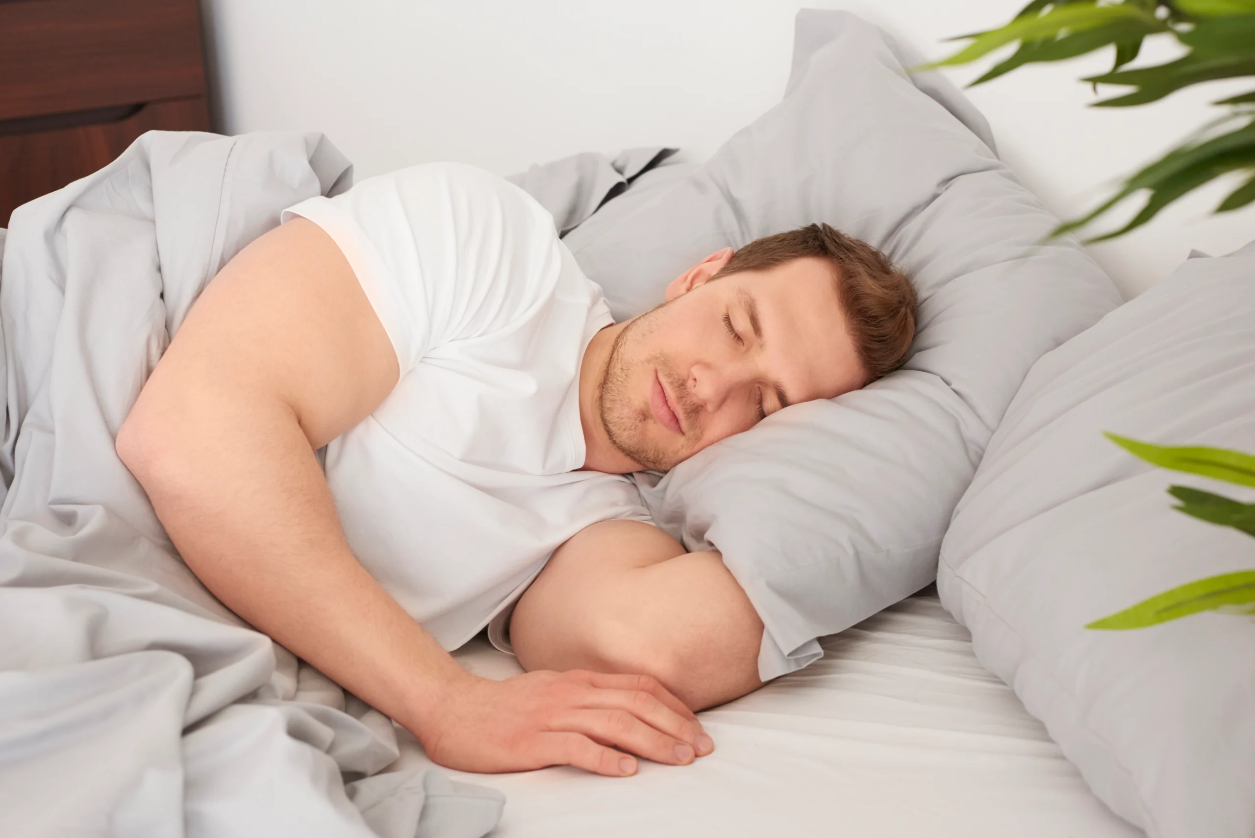 Man sleeping in a cozy bed