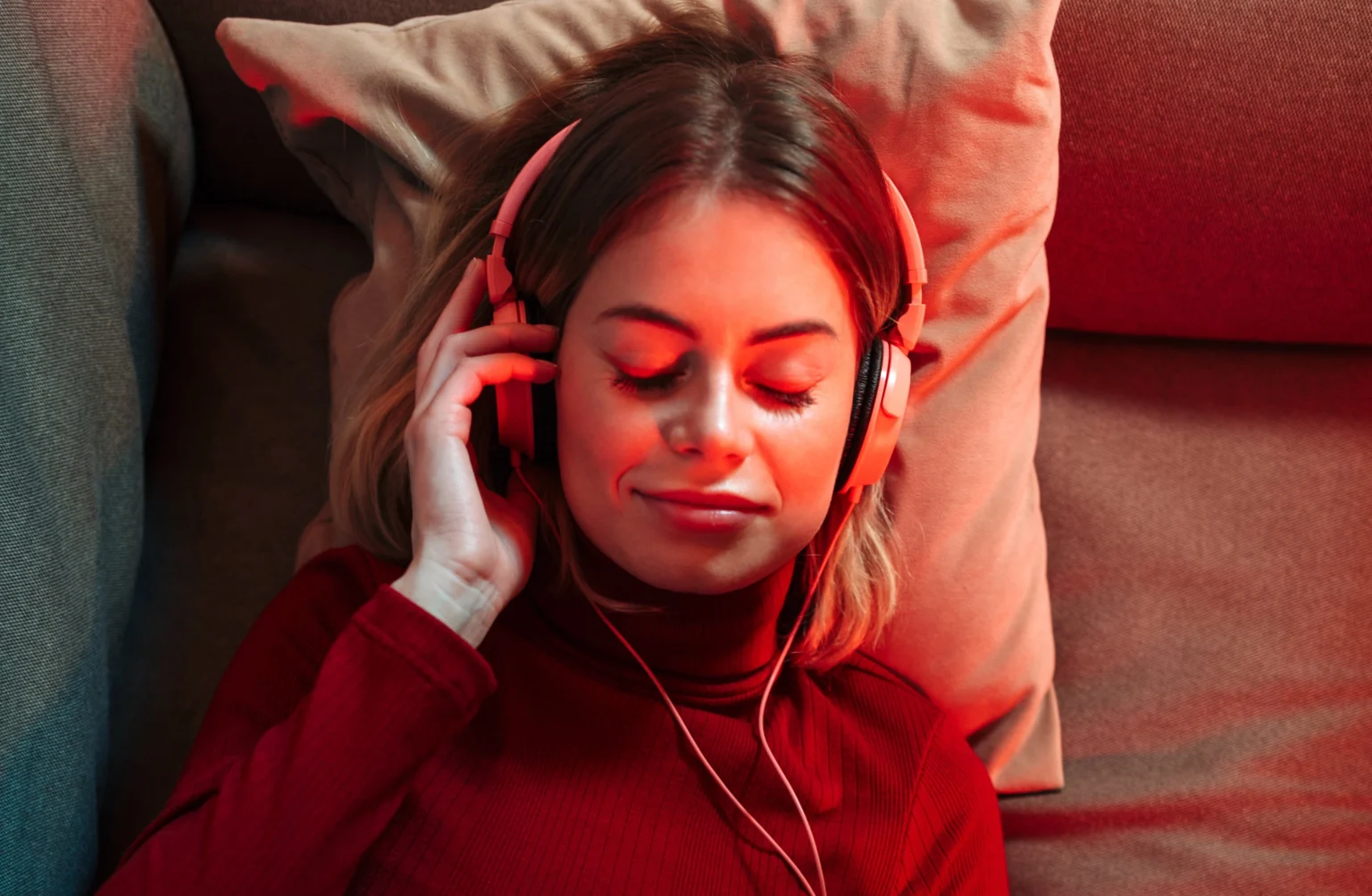 Woman doing red light therapy on the couch